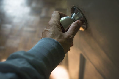 High angle view of man holding doorknob