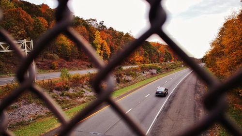 Road seen through chainlink fence