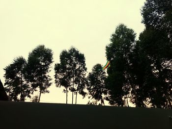 Silhouette trees against sky during sunset