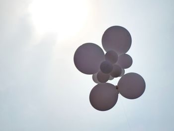 Low angle view of balloons against sky