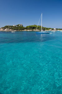 Scenic view of sea against clear blue sky