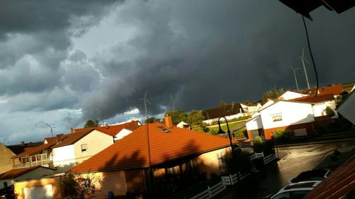 Houses against cloudy sky