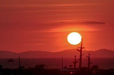 Scenic view of sea against orange sky