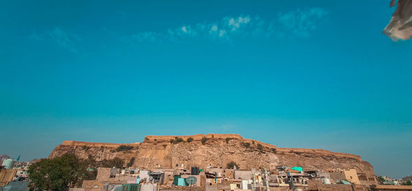 Panoramic view of historic building against blue sky