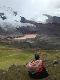 Rear view of woman on landscape against sky