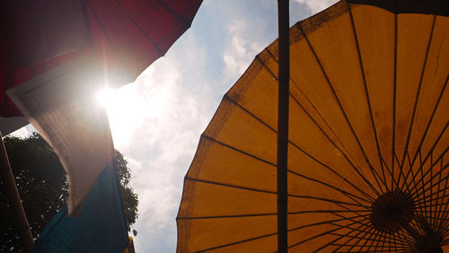 Low angle view of parasol against sky