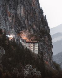 Rock formations by building against sky