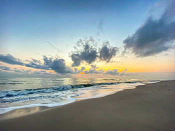 Scenic view of beach against sky during sunset