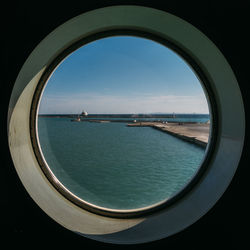 Panoramic view of sea seen through window