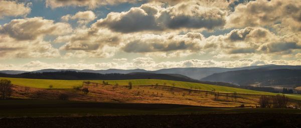 Scenic view of landscape against cloudy sky