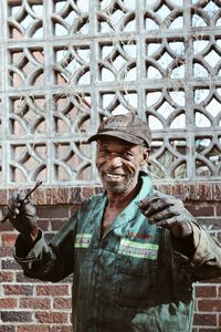 Portrait of smiling man standing against built structure