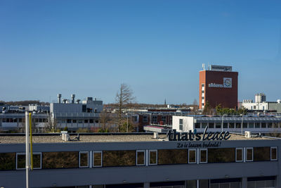 Buildings against clear blue sky in city