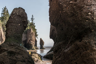 Rock formations by sea against sky