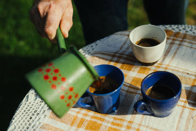 Cropped hand of person preparing food on table