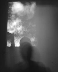 Portrait of silhouette person against window