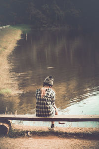 Man sitting at lakeshore