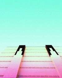 Low angle view of building against clear blue sky