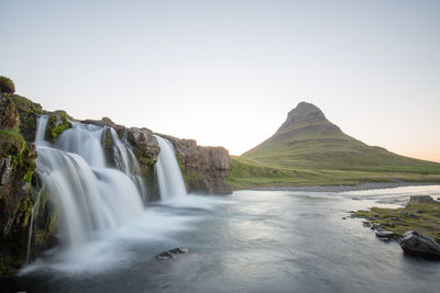 Scenic view of waterfall against sky