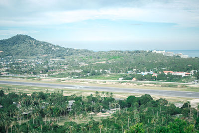 Scenic view of trees and buildings against sky