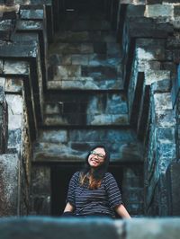 Portrait of woman sitting in corridor