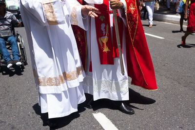 Procession in honor of santa luzia is accompanied by faithful and priests from the catholic church 