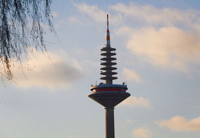 Low angle view of communications tower against sky