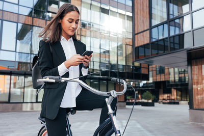 Portrait of young woman using mobile phone