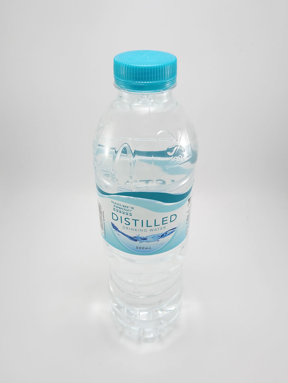 CLOSE-UP OF WATER BOTTLE ON WHITE BACKGROUND
