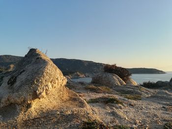 Scenic view of rocks against clear sky