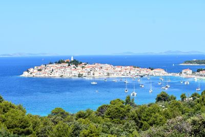 Scenic view of sea and city against sky