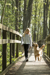 Girl walking on footbridge