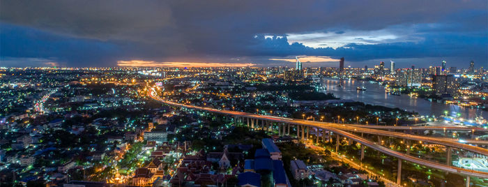 High angle view of illuminated city buildings at night