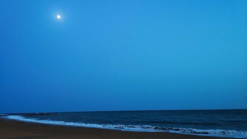 Scenic view of sea against clear blue sky