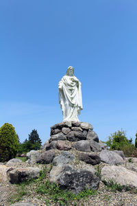 Low angle view of statue against rock