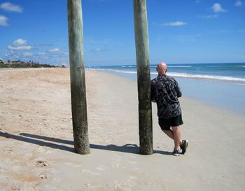 Full length of man on beach against sky