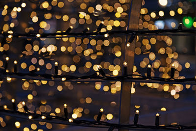 Small lights on long cords with lots of bokeh in the background