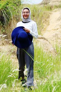 Portrait of woman standing on field