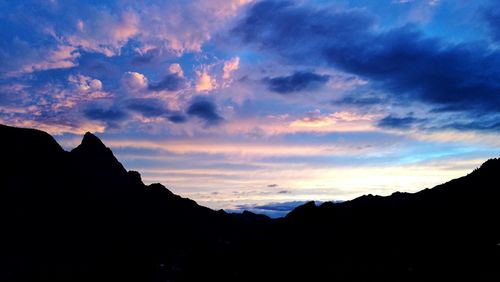 Silhouette mountains against sky at sunset