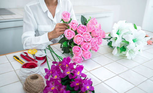 Midsection of woman holding bouquet