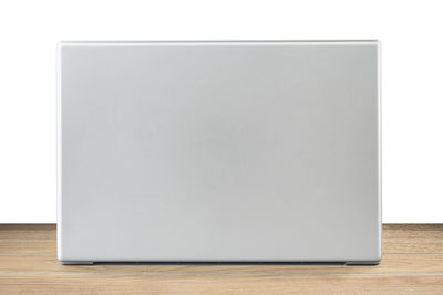 Close-up of empty table against white background