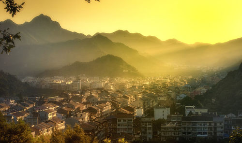 High angle shot of townscape against sky at sunset