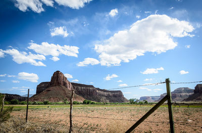 Fence on field against sky