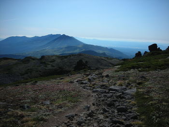 Scenic view of landscape and mountains against clear blue sky