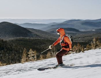 Skier speeds down slope on baldface mountain, new hampshire