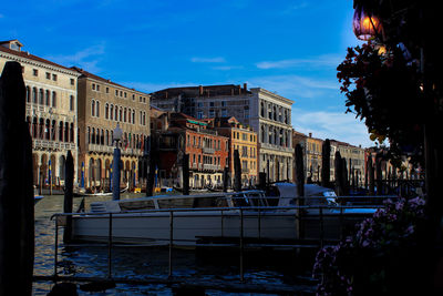 Boats in city against sky