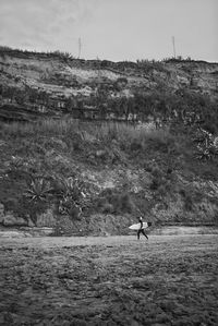 Man on field against sky