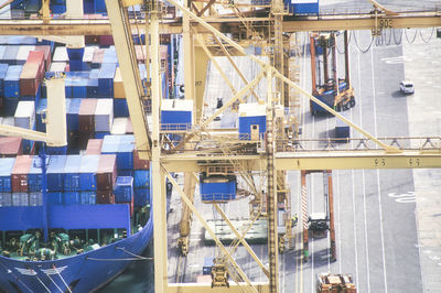 High angle view of cranes, cargo container and container ship at commercial dock, barcelona 