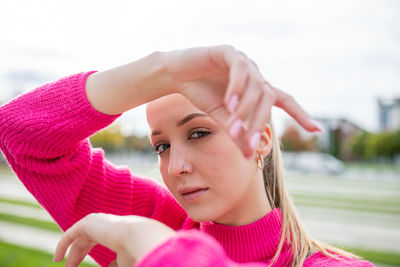 Portrait of young woman standing in city