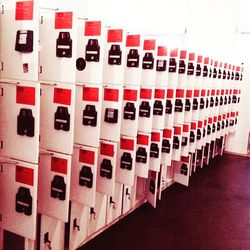 Row of red objects on tiled floor