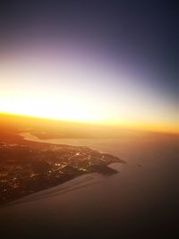 Aerial view of city against sky during sunset